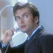 the tenth doctor holding a telephone